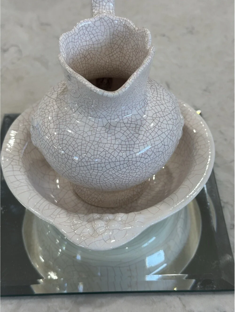 Farmhouse-style pitcher and basin set, featuring a distinct white crackle finish